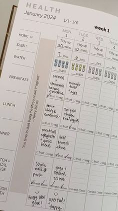 an open planner is sitting on top of a table with the words health written in it