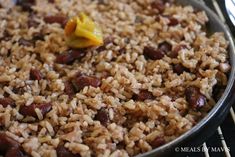 a pan filled with rice and beans on top of a stove