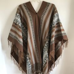 "This is a traditional heavy weight Andean poncho made by one of our most talented weavers. The natural fiber yarn is hand-dyed and woven into beautiful patterns and color arrangements. Perfect to keep you warm around ceremonial fires! There is yarn fringe at the bottom.  One size fits most adults. Unisex. Dimensions: 66\" x 44\" Peruvian woven textiles are incomparable in their quality and beauty. Add this to your collection today! We are a non-profit organization and proceeds from all sales go Traditional One Size Woven Poncho, Traditional Woven Shawl Poncho, Handwoven Folk Shawl One Size, Folk Style Handwoven Shawl, Handwoven Poncho Shawl For Festivals, Traditional Handwoven One-size Poncho, Traditional Handwoven Poncho One Size, Handwoven Festival Poncho Shawl, Traditional Festival Poncho With Woven Motifs