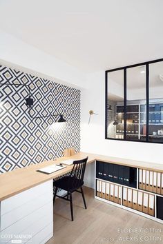 an office with a desk, chair and bookcases