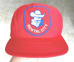 a red hat with the words rental city on it