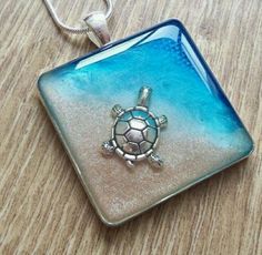 a glass pendant with a turtle on it