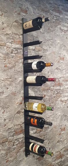 several bottles of wine are lined up on the wall