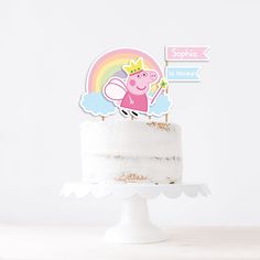 a peppa pig cake topper sitting on top of a white cake