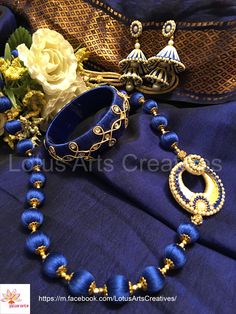 Raw dark blue  silk thread jewellery necklace with a cream colour side pendant, Kangan with zardosi work, blue and cream double jhumka.  Perfect choice for a chanderi / kanchivaram / Banarasi / silk saree or a silk cotton saree. Call or whatsapp +919840009398 to place your order. International and domestic orders accepted. https://m.facebook.com/LotusArtsCreatives/ Zardosi Work, Banarasi Silk Saree, Cream Colour