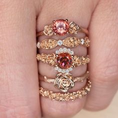 This beautiful and unique botanical stacking band features roses intricately rendered in 14k rose gold. Inspired by the boundless and surprising beauty of the natural world, these romantic beauties are gorgeous on their own or in a stack! The blushing warm of the rose gold is a pretty and apropos tribute to the flowers themselves. The ring is rendered in solid 14k rose gold, and the design continues all the way around the band. With its dreamy air of fairytale romance, this band would make an ex Rose Gold Flower Ring, Fairytale Romance, Botanical Ring, Beautiful Wedding Bands, Red Tourmaline, Gold Flower Ring, Red Tone, Rose Gold Flower, Artfully Designed