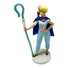 a figurine is holding a toothbrush in her hand