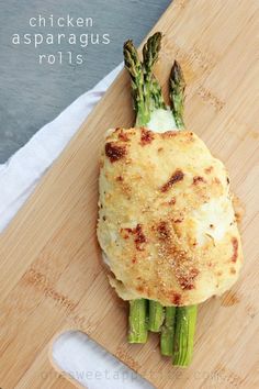 chicken asparagus rolls on a wooden cutting board