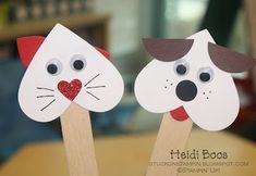 two paper cat and dog puppets on wooden sticks