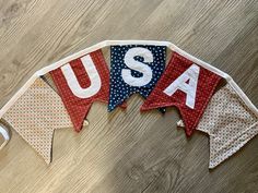 three patriotic buntings with the word usa on them sitting on a wooden floor