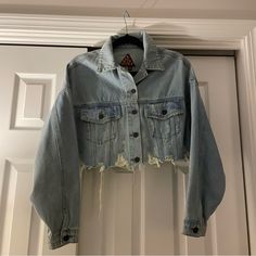 Grungy Cropped Denim/Jean Jacket Featuring A Lighter Wash And Distressed Fabric. Fit Is True To Size. Item Is New Without Tags (Never Been Worn), And In Excellent Condition. 100% Cotton. Perfect For A Concert Or Summer! Light Wash Cotton Denim Jacket With Frayed Hem, Cropped Denim Jacket With Frayed Hem, Fall Light Wash Denim Jacket With Frayed Hem, Trendy Fall Denim Top With Frayed Hem, Trendy Frayed Hem Denim Top For Fall, Casual Medium Wash Denim Jacket With Frayed Hem, Trendy Medium Wash Denim Jacket With Frayed Hem, Fall Denim Jacket With Frayed Hem, Edgy Denim Jacket With Frayed Hem For Streetwear