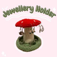 a crocheted mushroom with jewelry hanging from it's base and the words jewellery holder above it