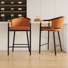 two bar stools sitting next to each other on top of a hard wood floor