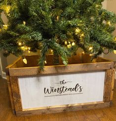 a christmas tree in a wooden box with lights on the top and words that read, the winestead's