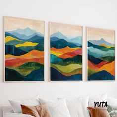 three paintings hanging on the wall above a couch