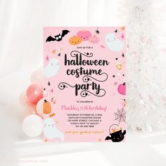 a pink halloween costume party card next to a white christmas tree with decorations and balloons