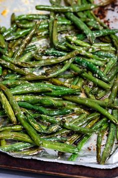 asparagus on a baking sheet ready to go in the oven for roasting