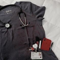 a doctor's uniform and other medical supplies laid out on top of a bed