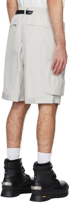 Polyester taffeta shorts. · Integrated FIDLOCK® cinch belt at elasticized waistband · Belt loops · Four-pocket styling · Mock-fly · D-ring hardware and logo plaques at front · Magnetic zip flap at outseams · Velcro tab at back cuffs · Full poplin lining Supplier color: Light gray Outdoor Nylon Shorts With Belt Loops, Nylon Bottoms With Belt Loops For Summer, Nylon Shorts With Belt Loops For Summer, Summer Nylon Shorts With Belt Loops, Cinch Belt, Track Shorts, D Ring, Color Light, Light Gray