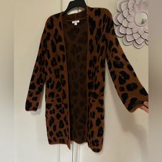 Nine West Size Small Leopard Print Never Worn Acrylic, Nylon Blend Long-Length Cardigan Front Pockets Trendy Long Brown Cardigan, Long Brown Sweater For Fall, Casual Leopard Print Winter Cardigan, Casual Leopard Print Cardigan For Winter, Long Brown Spring Sweater, Trendy Brown Open Front Cardigan, Casual Leopard Print Outerwear For Layering, Winter Brown Open Front Outerwear, Casual Brown Outerwear For Layering