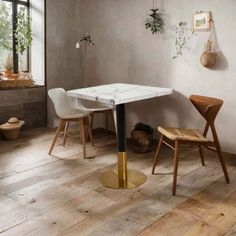 a dining room with two chairs and a table