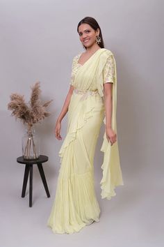 Ruffle saree with blouse/yellow ruffle saree with stitched blouse/ saree belt with blouse /light yellow  silk ruffle saree / saree with belt / belt sari/ voggish / yellow cocktail saree     Here is the beautiful modern georgette ruffle saree in light yellow color paired with hand embroidered designer blouse and matching embroidered belt as shown !! Perfect and stands out in any occasion!!        Fabric details :   Saree : soft viscous georgette Blouse/belt : pure raw silk with hand embroidery , Yellow Ruffle Saree, Tiered Saree, Cocktail Saree, Saree Belt, Saree With Belt, Ruffle Saree, Embroidered Belt, Drape Saree, Yellow Saree