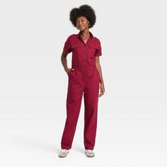 Elevate your wardrobe with this Boilersuit from Universal Thread™. Made from recycled cotton with added spandex, this boilersuit features relaxed-fit legs and an ankle length. The boilersuit comes in a short-sleeve design with a collared neckline and boasts multiple pockets for practicality. The elastic waistband and front buttons add extra flair for an on-trend look. Universal Thread™: Found exclusively at Target. Utility Jumpsuit Outfit, 2024 Planning, Cargo Jumpsuit, Fall Sewing, Boiler Suit, Leg Cuffs, Women Maxi, Hem Style, Denim Jumpsuit