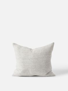 a white pillow sitting on top of a table