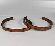 The inscription in Hindi on one of these handmade copper bracelets translates to "Adoration to Lord Shiva." The other bracelets Hindi inscription reads as "Sri Pashupatinath," referring to either the Hindu temple by that name or as "Lord Shiva.' Both bracelets are 2.75 in across, which is adjustable by gently bending the bracelet to the desired size. The two copper mantra bracelets in this 2-piece lot are in very good condition, copper color, very light patina, light wear, all commensurate with age and use. Please see photos for further assessment. Adjustable Spiritual Bronze Bracelets, Adjustable Bronze Spiritual Bracelets, Spiritual Adjustable Hand Stamped Bracelets, Adjustable Spiritual Hand Stamped Bracelets, Adjustable Spiritual Bracelets For Ceremonial Use, Adjustable Bronze Spiritual Bangle, Spiritual Engraved Bracelets For Friendship, Spiritual Engraved Bracelet For Friendship, Spiritual Copper Cuff Bracelet As Gift