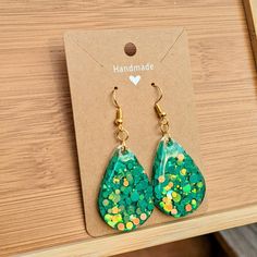 One pair of handmade teardrop-shaped earrings Made with bright, green confetti and epoxy resin  The perfect pair of groovy earrings for welcoming the warmer weathers, celebrating special moments and more! Each pair is assembled with hypoallergenic, nickel-free ear wire and safe for sensitive ears ---------------------------- RESIN CARE - Avoid long periods of direct sunlight to prevent yellowing - Wash with a very mild soap, warm water and a non abrasive cloth - Avoid submerging in water (remove Groovy Earrings, Green Confetti, Diy Resin Projects, Resin Projects, Diy Resin, Resin Earrings, Resin Diy, Sensitive Ears, Jewelry Handmade