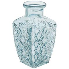 a clear glass vase sitting on top of a white table