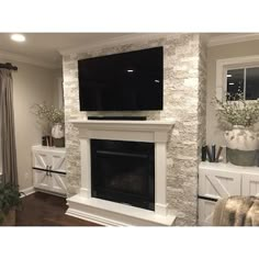 a large flat screen tv mounted above a fireplace