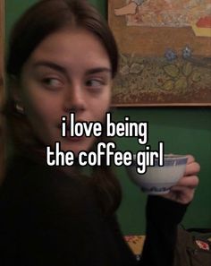 a woman holding a cup with the words i love being the coffee girl