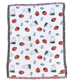 a blanket with rabbits and strawberries on it