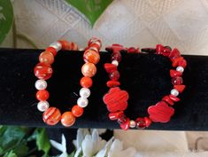 Orange beaded and red floral bead bracelets that stretch. Perfect for small to medium wrist. Acrylic beads with different shades beads with designs. perfect for younger girls Bohemian Red Flower Bracelets, Red Bohemian Flower Beaded Bracelets, Red Flower-shaped Bohemian Beaded Bracelets, Bohemian Red Flower Beaded Bracelet, Red Flower-shaped Handmade Bracelets, Red Bohemian Beaded Bracelets With Heart Beads, Bohemian Red Beaded Bracelets With Heart Beads, Casual Red Hand-strung Bracelets, Handmade Red Flower Bracelets