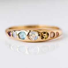 Yowza... The She's an Artist Ring is a serious showstopper. Pink opal, peach moonstone, citrine, opal, aquamarine, chalcedony, amethyst on front with a teeny tiny rainbow moonstone on the back! Love is an understatement, we're obsessed! Pink opal 1.5mm Peach moonstone 2mm Citrine 2.5mm Opal 3mm Aquamarine 2.5mm Chalced Colorful Wedding Ring, Pink Moonstone, Local Eclectic, Wink Wink, Rainbow Sapphires, Moonstone Engagement, Sand Casting, Silver Wedding Bands, Peach Moonstone