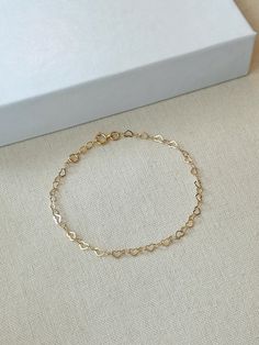 Hearts are melting for this dainty yet durable mini heart chain bracelet! 💛 This unique chain is sensitive skin and water safe, and is made to live your life in! Wear this minimal piece to brunch, or on a date... this simple heart chain looks lovely anywhere you take it! Details: * 3.5mm 14K Gold Filled heart chain * Dainty 14K Gold Filled spring clasp * 14/20 gf stamp for authenticity * Choose your length (each bracelet comes with a .5" extender chain for adjustable sizing.) * Made with all hypoallergenic and water safe materials 🤍 ✨ Pairs well with the Mini Heart Chain Necklace https://etsy.me/40aqcLB BRACELET MEASURING GUIDE: Average Women's Sizing: 5-6 inches = xtra small 6.5-7 inches = small 7-8 inches = medium 8 inches+ = large Please make sure to measure to get the right fit! Each Minimalist Gold Bracelet, Heart Chain Bracelet, Bracelet Love, Bracelet Minimalist, Basic Jewelry, Heart Chain, Love Bracelet, Keepsake Jewelry, Bff Gifts