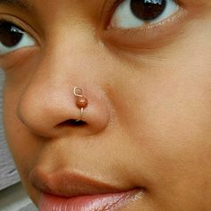 a close up of a person with a nose ring on their nose and nose piercing