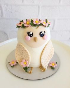 a cake decorated with an owl and flowers