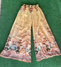 "Vintage sheer floral print palazzo pants. These pants are so fabulous! They almost look like they could have been homemade. They don't have any tags anywhere on them. They fit like an extra small. They feel like a polyester, cotton, and nylon blend. They have an elastic waist. No Pockets. They're in great condition.  Measurements laying flat Across the waist 11\" (22\" total) Elastic waist stretches to about 16\" (32\" total) Top to bottom 37\" Items are shipped out within 1-2 business days. If Full Length Floral Print Wide Leg Pants For Summer, Bohemian High-waisted Wide Leg Pants With Floral Print, Bohemian High-waisted Floral Print Pants, Bohemian Floral Print Trousers, Hippie Wide Leg Floral Print Bottoms, Hippie Wide-leg Bottoms With Floral Print, Bohemian Wide Leg Bottoms With Floral Print, Hippie Wide Leg Bottoms With Floral Print, Bohemian Wide-leg Floral Print Bottoms