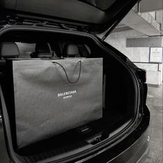 a bag is sitting in the trunk of a car