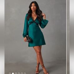 The Jazzy Satin Lace Trim Long Sleeve Mini Dress Features A Lace-Trimmed V-Neckline And Long Sleeves With Elastic Cuffs. It’s Ultra-Feminine In A Romantic Shade And Satin Fabric, Which Is Perfect For Date Night Or Special Occasions. Lace-Trimmed V-Neckline & Under Bust Emerald Color Balloon Long Sleeves With Elastic Cuffs Back Neck Ties Mini Length Smooth, Satin Fabric Side Zipper Closure 95% Polyester 5% Spandex New With Tags, Vici Green Mini V-neck Evening Dress, Fitted Green V-neck Chic Dress, Chic Fitted Green V-neck Dress, Elegant Green Mini Dress With Surplice Neckline, Green V-neck Party Dress With Surplice Neckline, Green V-neck Dress With Surplice Neckline For Party, Green Wrap V-neck Party Dress, Green V-neck Dress For Date Night, Green V-neck Mini Dress For Formal Occasions