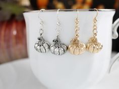 Add a festive touch to your jewelry collection with these delightful pumpkin earrings!  Made with .925 sterling silver and hung from .925 sterling silver ear wires, these pumpkin earrings will add a touch of whimsy to your fall outfits or surprise a friend with this charming gift. Whether you wear them to fall festivals, Thanksgiving gatherings, or Halloween parties, these pumpkin earrings are sure to grab attention. Embrace the spirit of the season and celebrate the magic of autumn with these d Halloween Sterling Silver Dangle Earrings, Elegant Fall Jewelry Gift, Elegant Fall Jewelry For Gifts, Silver Earrings For Halloween Gift, Halloween Sterling Silver Dangle Jewelry, Sterling Silver Dangle Jewelry For Halloween, Fall Season Gift Dangle Earrings, Halloween Silver Drop Earrings, Silver Drop Earrings For Halloween