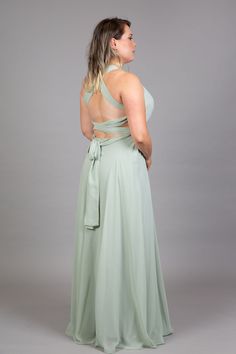 a woman in a green dress looking back