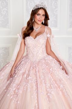 a woman in a pink ball gown and tiara