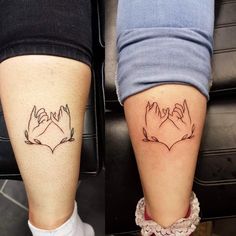 two people with tattoos on their legs, one has hands and the other has hearts