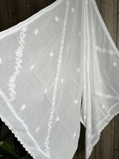 Classic white Chikankari pure cotton dupatta with hand embroidery and crochet lace. Luxury Chanderi Fabric With Chikankari Embroidery, Luxury Chikankari Embroidery Maxi Length Dupatta, Luxury Festive Chikankari Embroidery Dupatta, Bohemian Cotton Dupatta With Chikankari Embroidery, Traditional White Cotton Embroidered Fabric, Unstitched White Chikankari Embroidered Fabric, White Embroidered Mulmul Dupatta, White Cotton Embroidered Dupatta Fabric, Bohemian Mulmul Dupatta With Chikankari Embroidery