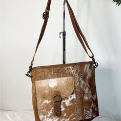 Myra Bag Genuine Hair-On Cowhide Leather Crossbody Bag With Front Pocket Introducing Myra Women's Genuine Hair-On Cowhide Leather Crossbody Bag. This Charming Bag Is Lightweight And Features A Beautiful Color Combination Of White, Black, And Brown. The Bag Is Made From Premium Cowhide Leather And Is Sure To Become Your Favorite. {Perfect For Day Or Weekend Trips} Myra Women's Genuine Hair-On Cowhide Leather Crossbody Bag Is A Perfect Accessory For The Modern Woman, It's Spacious And Has Multiple Brown Saddle Bag With Double Handle, Light Brown Shoulder Bag With Detachable Strap For Everyday, Light Brown Leather Shoulder Bag, Light Brown Everyday Shoulder Bag With Detachable Strap, Beige Leather Flap Bag With Leather Handles, Brown Leather Shoulder Bag With Adjustable Strap, Brown Saddle Bag With Double Handle And Removable Pouch, Brown Crossbody Shoulder Bag With Removable Pouch, Light Brown Crossbody Bucket Bag With Adjustable Strap