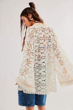 So cool and classic, this goes-with-anything kimono is the perfect piece to pair over anything from a basic bikini to a timeless tank. **Features:** Crochet fabrication, embroidered detailing at front, bell sleeves, tie-front closure, sheer design, lace-adorned trim **Why We ❤ It:** The true definition of an effortless essential, this wear-anywhere kimono is sure to be the top addition to your warm weather collection. | Bell Sleeve Lace Kimono by Free People in White White Tops With Kimono Sleeves For Summer, Fitted Summer Kimono With Embroidery, Fitted Embroidered Summer Kimono, Fitted Summer Embroidered Kimono, White Kimono Sleeve Beach Tops, White Kimono Sleeve Top For Beach, White Beach Tops With Kimono Sleeves, Cotton Open Front Tops For Beach, Open Front Cotton Tops For Beach