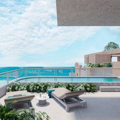 a balcony with lounge chairs overlooking the ocean